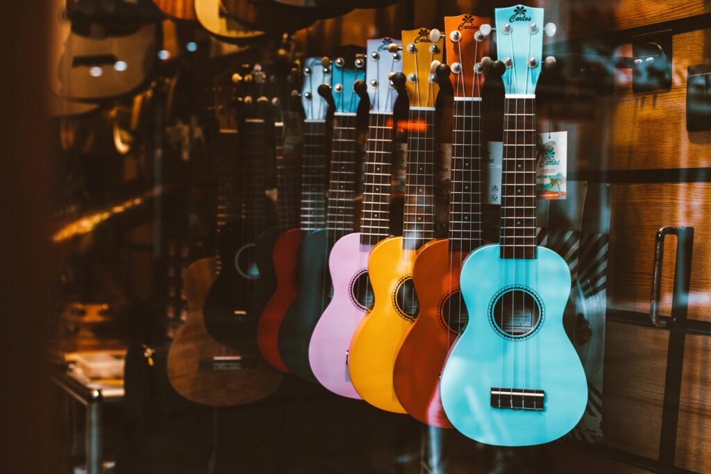 Vibrant ukuleles hanging in a shop window, showcasing musical instruments.